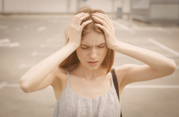 Depressed young woman, outdoors