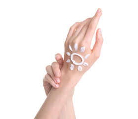 Young woman applying hand cream against on white background