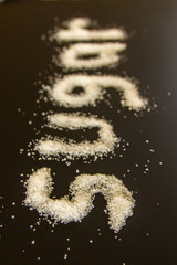 sugar spelled out with grains of white sugar