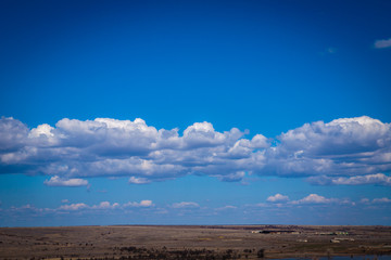white cumulus clouds against blue sky. background