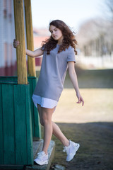 beautiful girl in the park outdoors, posing looking at the camera