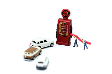 Miniature people : businessman and worker with gas station pump.