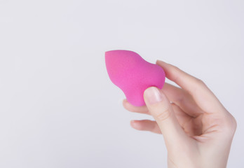 Macro shot of a hand with famous beauty blender.