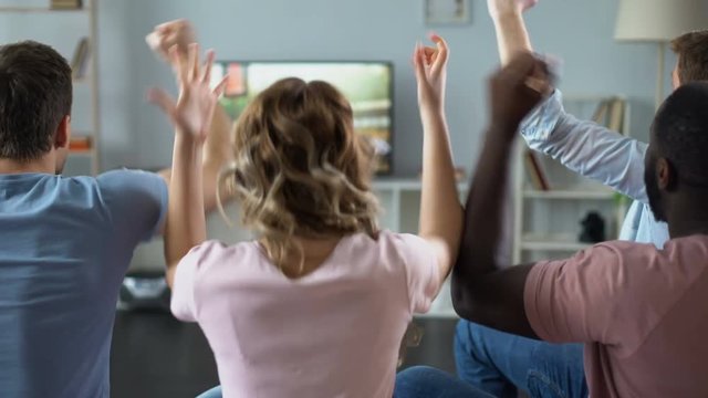 Cheerful friends chanting to support national football team at competition