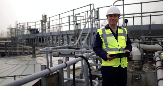 Portrait of industrial worker using a digital tablet on site