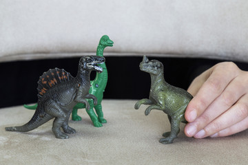 play with dinosaurs in the school. dinosaur and hand on the ground for children activities.