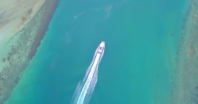 Aerial 4K:  Boat pass water channel near  Phangan island,popular tourist destination in Thailand