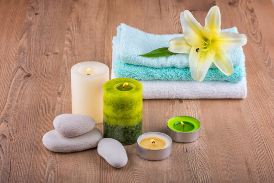 Spa decoration with candles, towels and spa stones