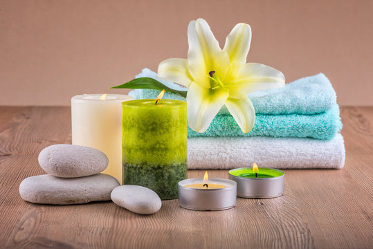 Spa decoration with candles, towels and spa stones