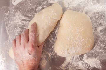 Obraz premium Hand shaping and preparing bread