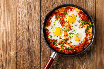 Shakshouka, dish of eggs poached in a sauce of tomatoes, chili peppers, onions