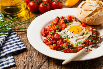Shakshouka, dish of eggs poached in a sauce of tomatoes, chili peppers, onions