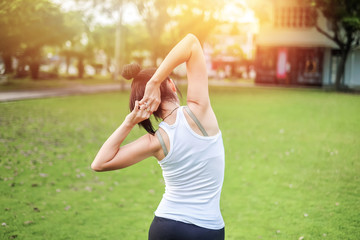 Asia beautiful woman exercising in the green garden.yoga and meditation concept.