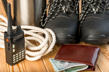 winter boots, walkie-talkie, strong rope and some money for a dangerous winter hike - objects close-up