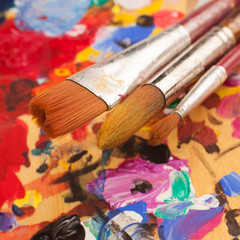 Obraz premium Artist. Creativity. Art. Set of brushes on wooden palette stained with paints