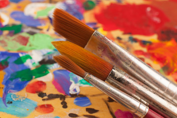 Obraz premium Painting. Set of brushes on the palette stained with paints