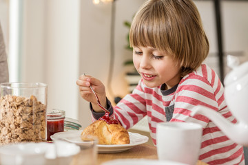 Hungry boy eating breakfast