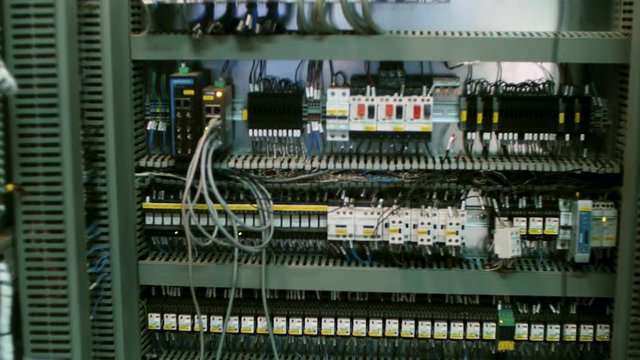 Wires in a box of distribution of an electricity. Clip. Electrical panel with fuses and contactors. Several contactors arranged in a row in an electrical closet