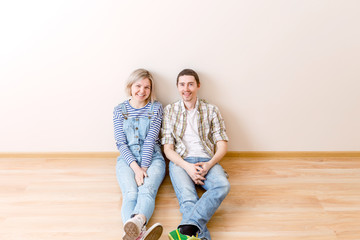 Photo of man and woman sitting on floor