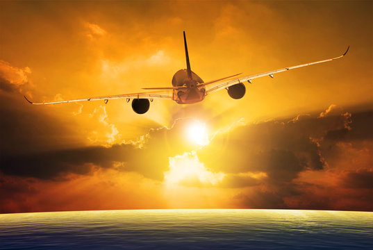 passenger plane flying over beautiful sunset sky