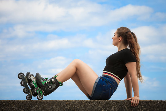Happy young woman wearing roller skates