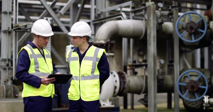 Industrial workers using a digital tablet on site