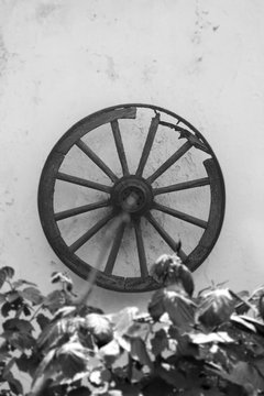 Old Horse Cart Wooden Wheel Hanging On The Wall