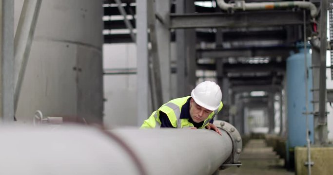 Industrial worker checking pipeline