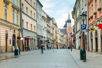 tourists on Florian street, view of the Mariinsky church in the center of Krakow, Poland