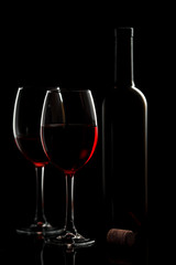Glass with red wine on a black background