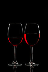 Glass with red wine on a black background