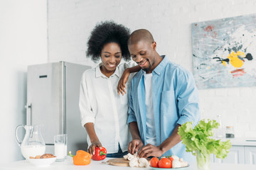 portrait of african american cooking breakfast together in kitchen at home