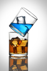 Two Glasses with Colorful Drinks with Ice Cubes