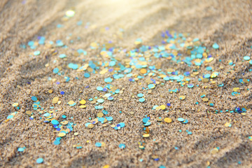 Green, blue or turquoise Soft Blurred Boke Background. Spangles and Shiny Silver Color Background. Bright Background. Glamorous background for your design and decoration. Sparkles on the sand. Magic