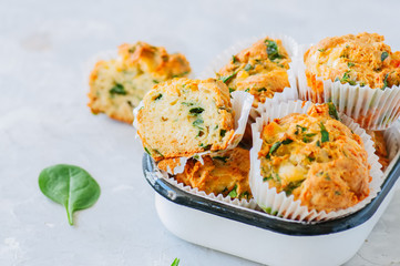 Savory potato spinach and feta muffins in a bowl. White stone background. Copy space.