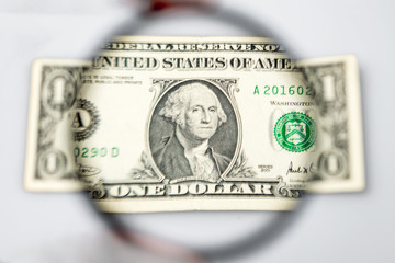 One  dollar banknote through a magnifying lens. Blurred background.