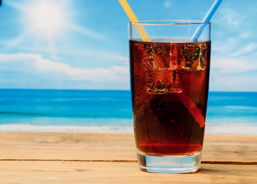 A cold drink in a glass on the beach, a delicious soft drink in the summer