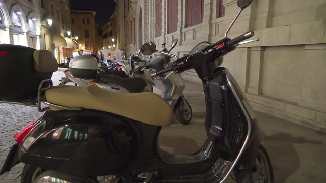 2445_The_small_motorcycle_parked_outside_the_streets_in_Italy.mov