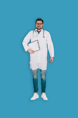 top view of male doctor with stethoscope and clipboard isolated on blue background