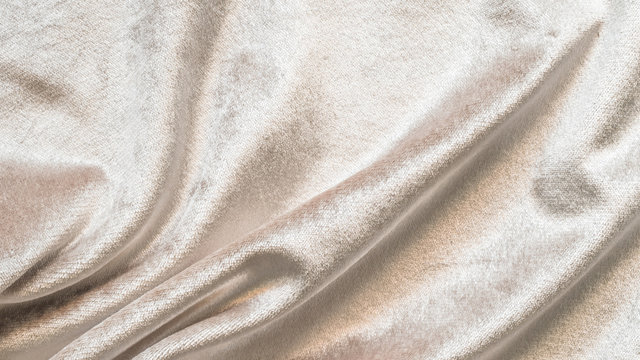 Beige gold velvet background or velour flannel texture made of cotton or wool with soft fluffy velvety satin fabric cloth metallic color material