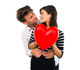Fototapeta na wymiar Young teenager couple holding a heart toy on isolated white background
