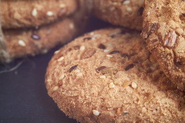closeup oat large biscuits with sesame, flax and sunflower seeds. Macro