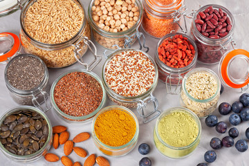 Various superfoods goji berries, quinoa, chia, hemp seeds, flax seeds, chickpeas, oats, almond, blueberries, curcuma, matcha and lantils. Vegan, vegetarian healthy eating diet organic products concept