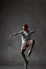 Fototapeta na wymiar Young beautiful male dancer posing in studio