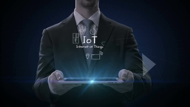 Businessman lifting a smart pad, tablet, Hand drawing various Internet of things icon. 4K size Movie.