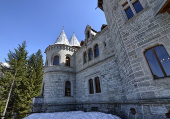 Fototapeta na wymiar Gressoney-Saint-Jean, Valle d'Aosta region, Italy. 25 April 2018. Castel Savoia, is a villa built in the late 1800s in eclectic style. In a fairytale context, photos of the exterior. Sunny day.