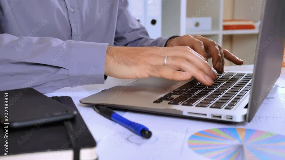 Aufkleber close up details employee typing on keyboard. married man sitting at the white desk with paper document different financial charts graphics and tables. fingers businessman entering data on laptop