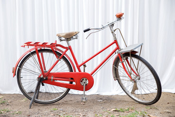 Fototapeta na wymiar Red bike on a white fabric scene.