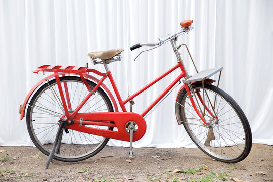 Red bike on a white fabric scene.