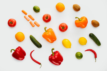 top view of pattern of colored fruits and vegetables isolated on white